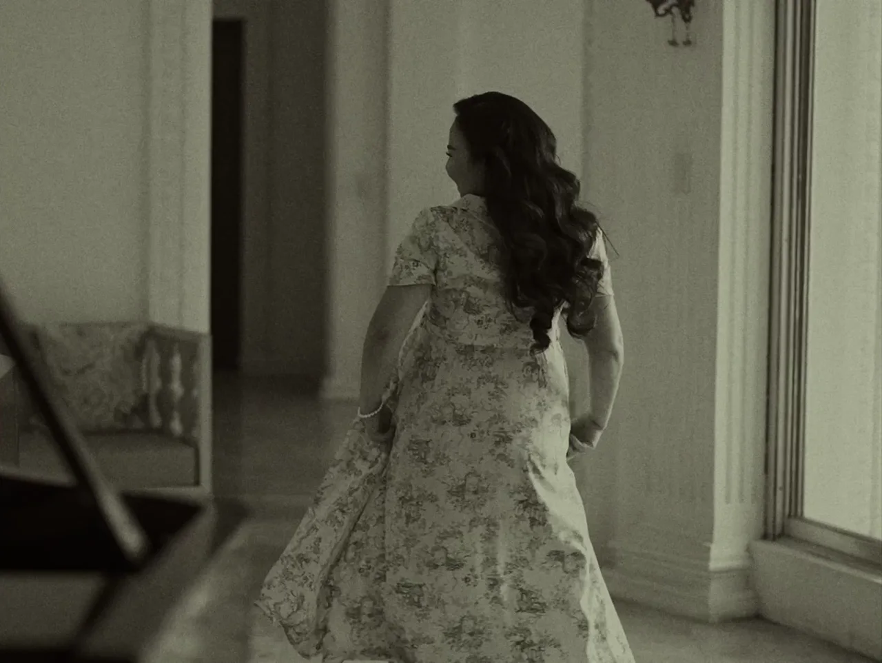 Elaine turning in the hall, in black and white