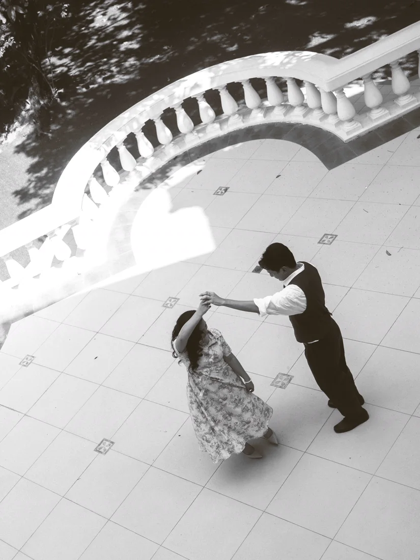 The two of them dancing, seen from above, in black and white
