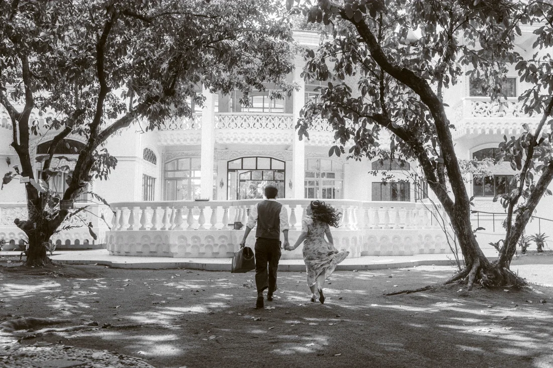James and Elaine running across the lawn, in black and white